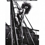 A black and white photo of a woman on a ladder.