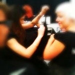 A blurry picture of a woman getting her hair done.