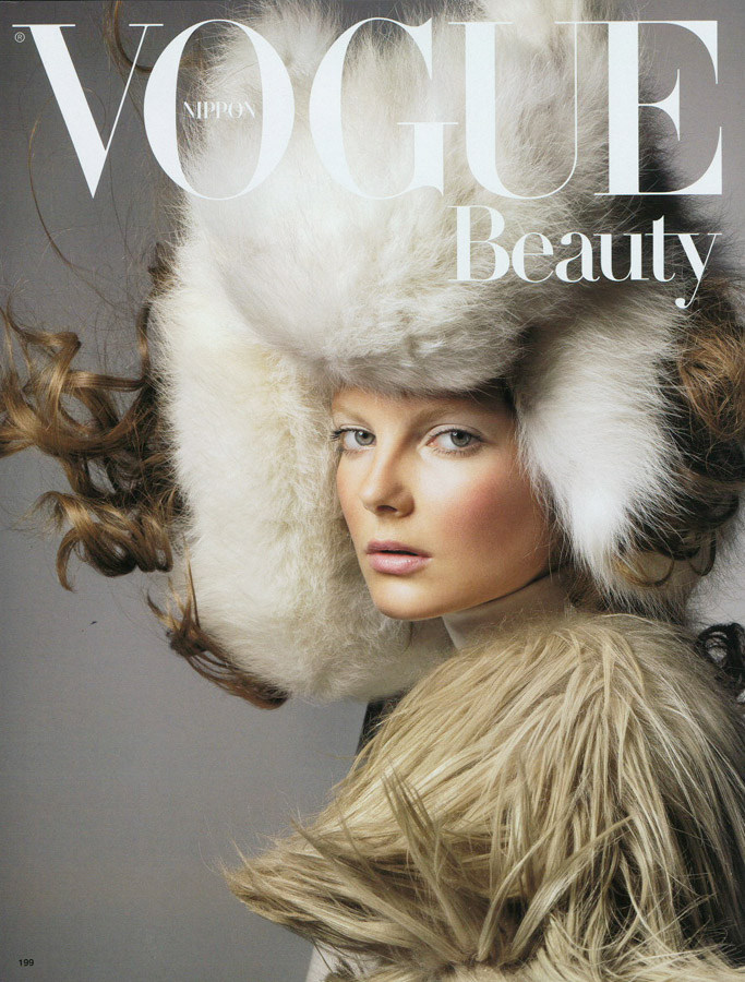 A woman in a fur hat on the cover of vogue beauty.