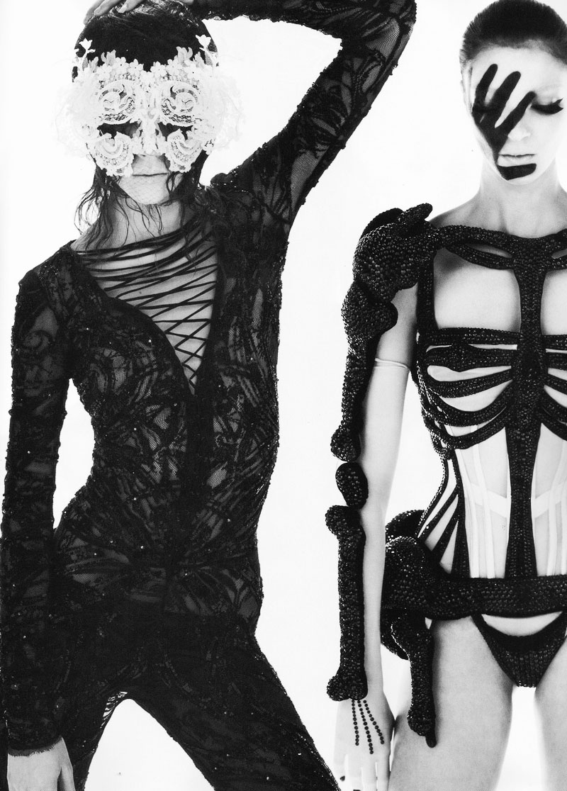 A black and white photo of two women in skeleton outfits.