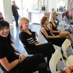 A group of women sitting in chairs at a salon.