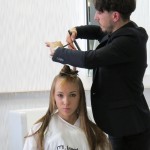 A man is cutting a woman's hair.