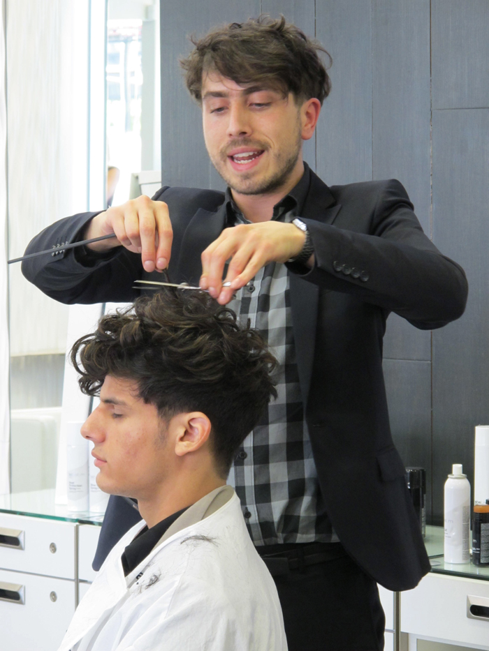 A man cutting a man's hair.