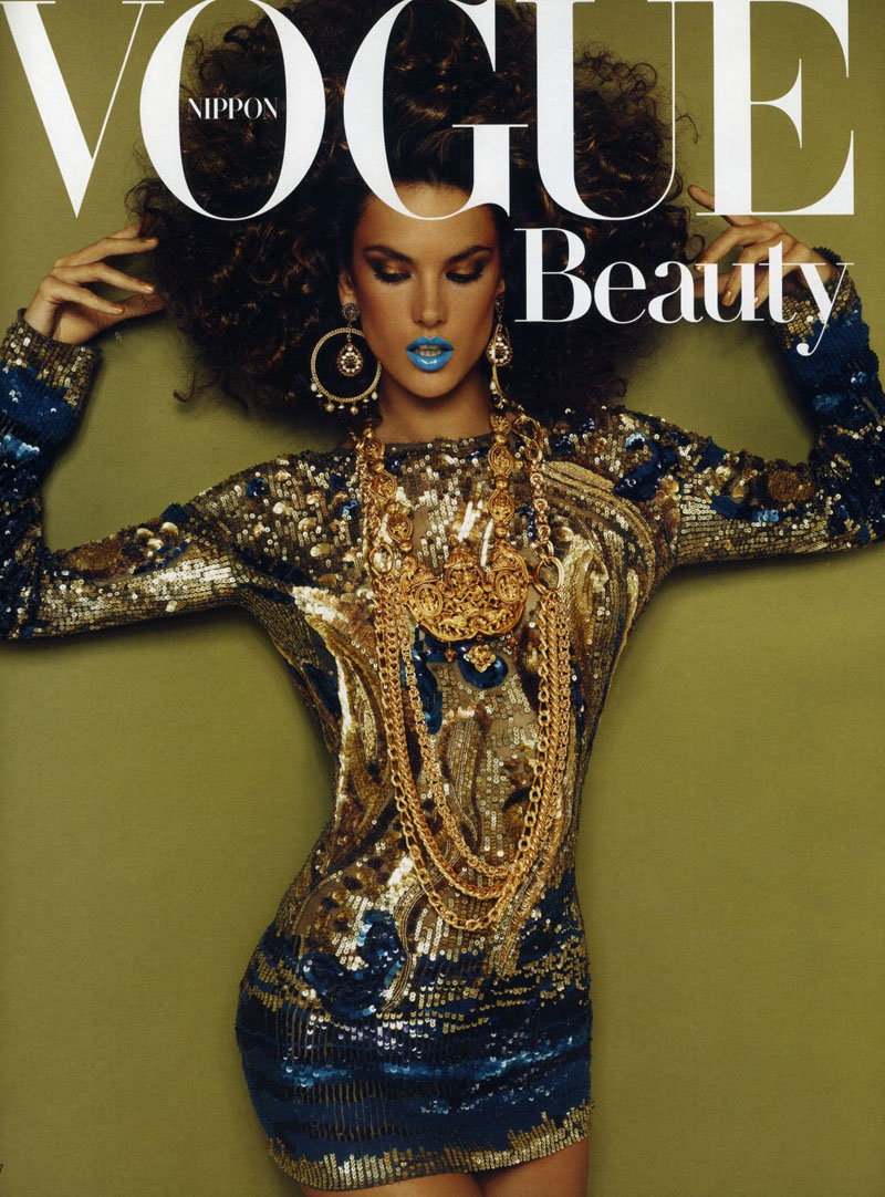 A woman in a blue dress on the cover of vogue beauty.