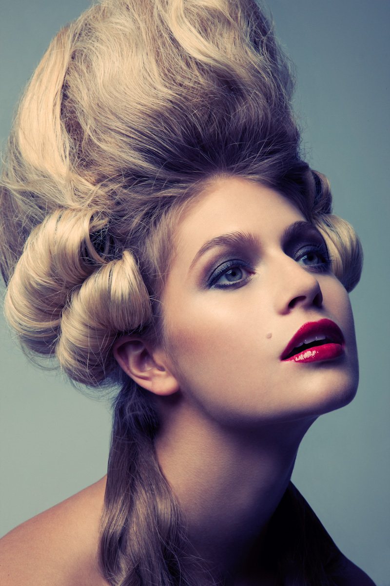 Blond woman with curly hair posing for a photo.