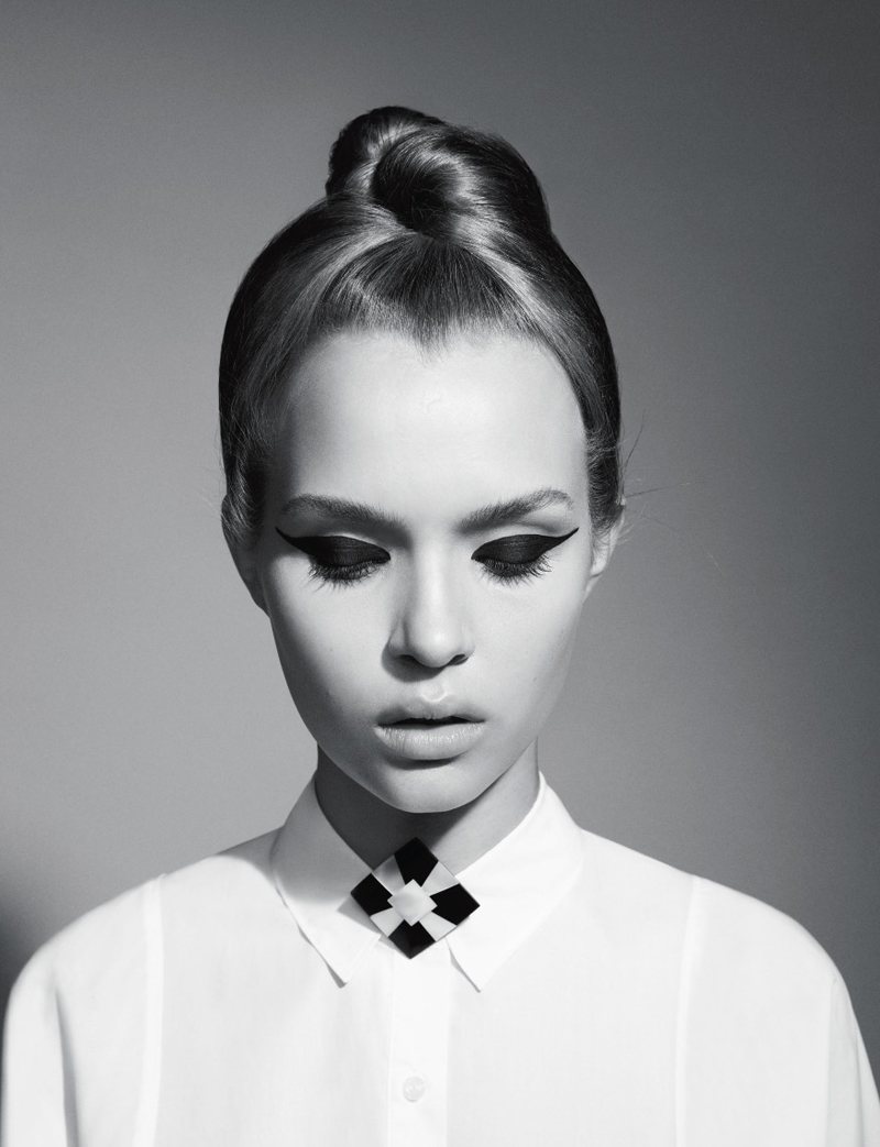 A black and white photo of a woman wearing a white shirt.