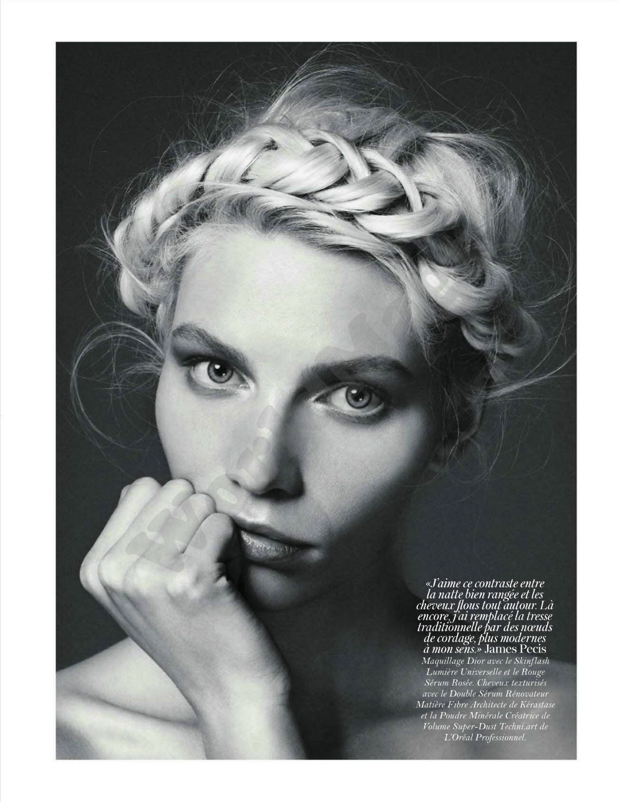 A black and white photo of a woman wearing a braided hairstyle.