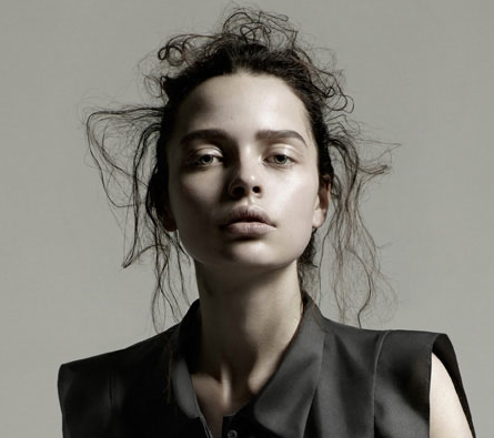 A woman in a black shirt posing for a photo shoot.