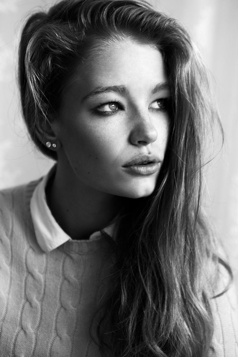 A black and white photo of a woman with long hair.