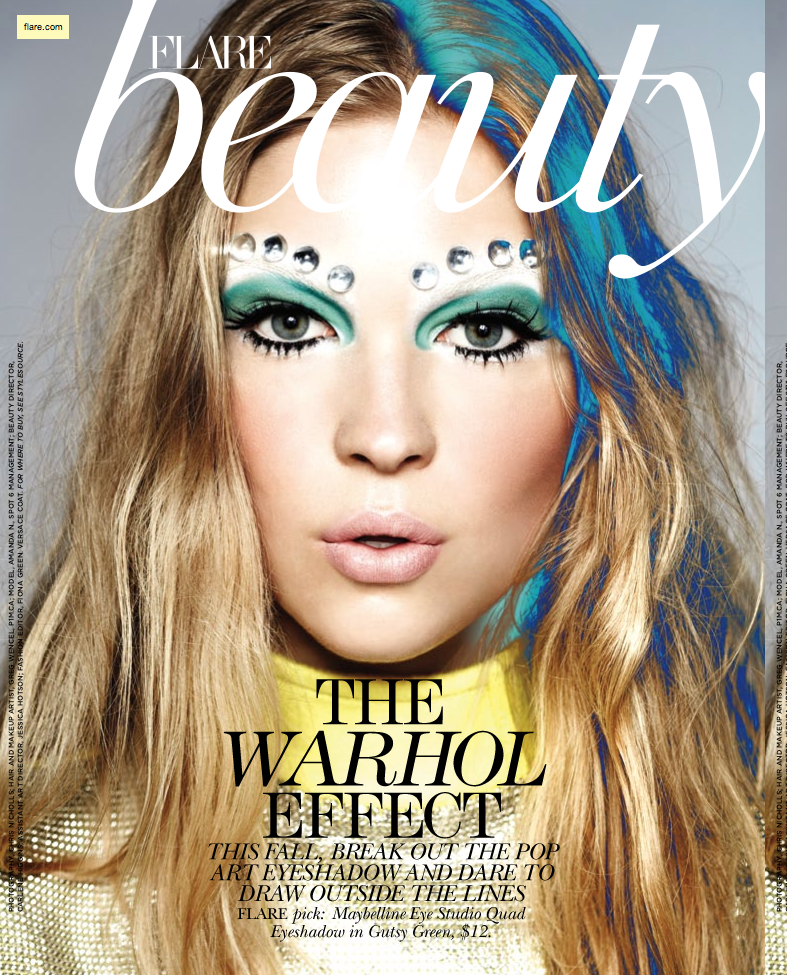 A woman with blue makeup on the cover of flame beauty.