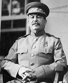 A man in military uniform sitting in a chair.