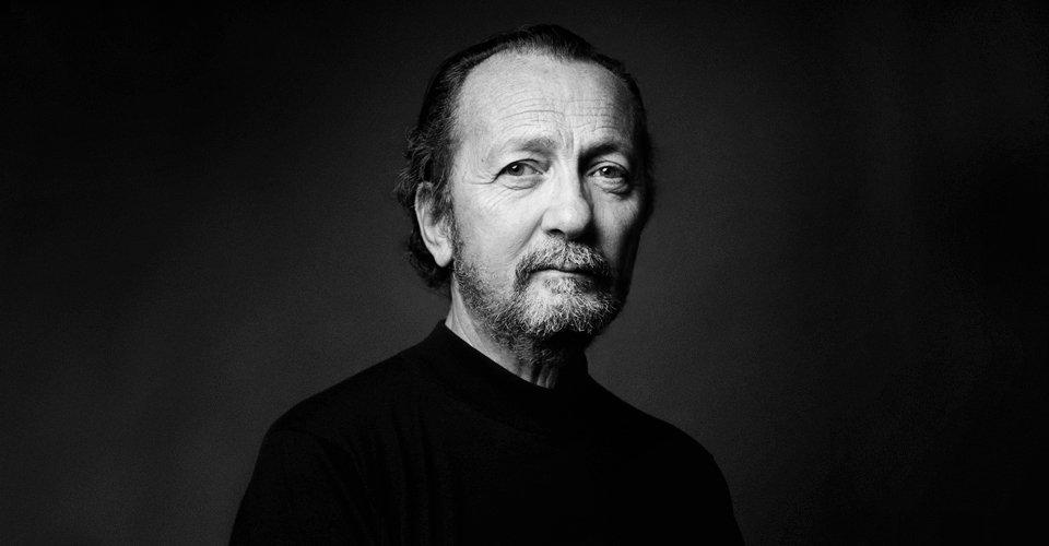 A black and white photo of a man with a beard.