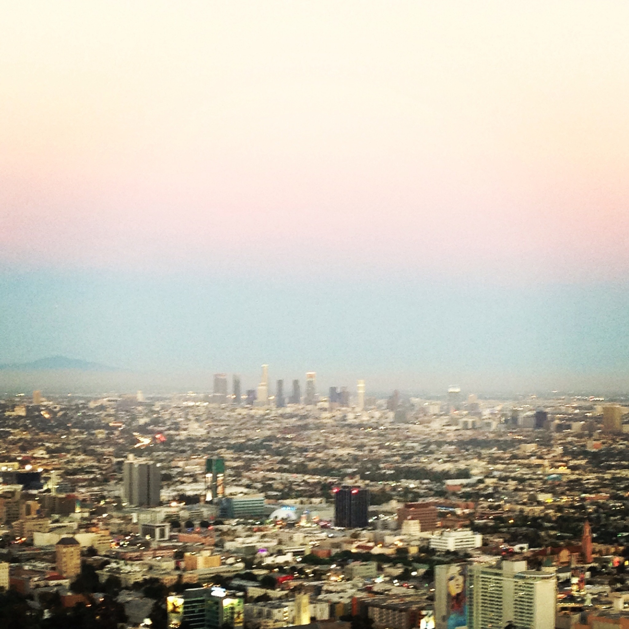 A view of the city from the top of a hill.