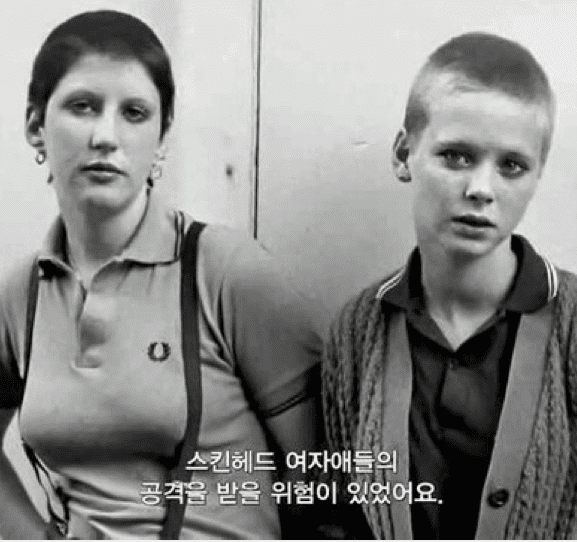 A black and white photo of two boys standing next to each other.