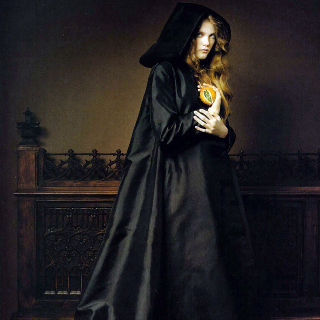 A woman in a black cloak.