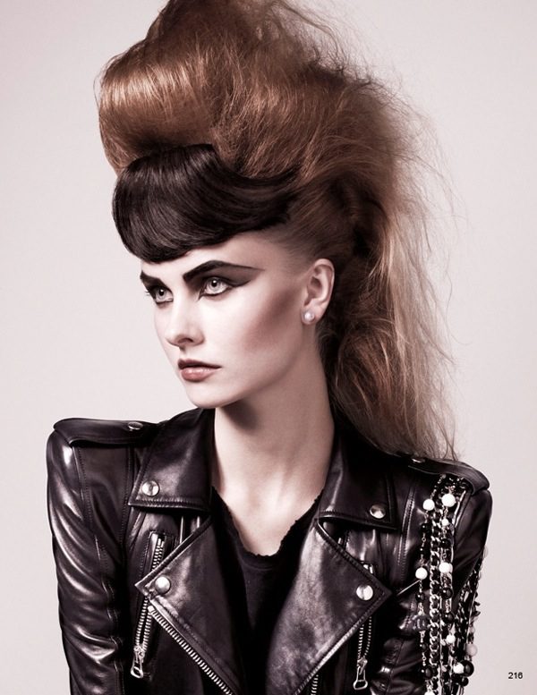 A woman in a leather jacket with a big hairdo.