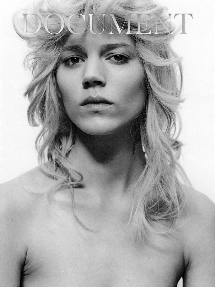 A black and white photo of a woman with long blonde hair.