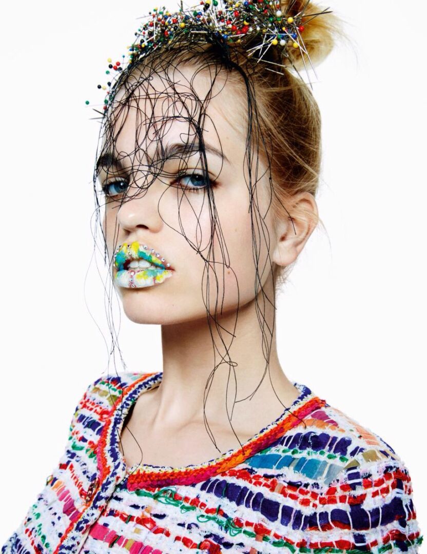 A woman wearing a colorful outfit with wires on her face.