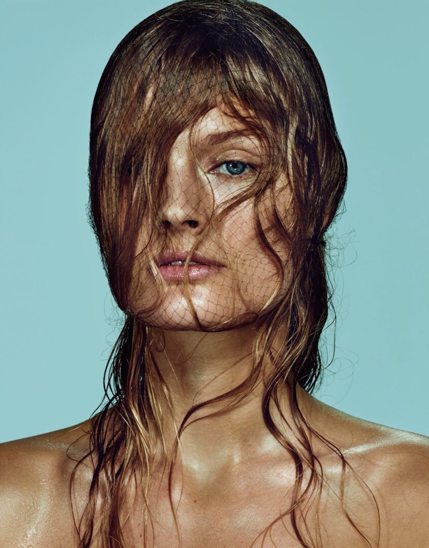 A woman with wet hair posing for a magazine.