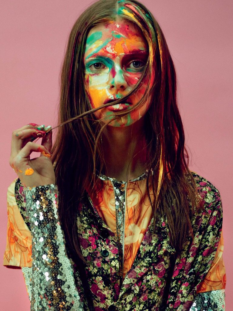 A woman with colorful paint on her face.