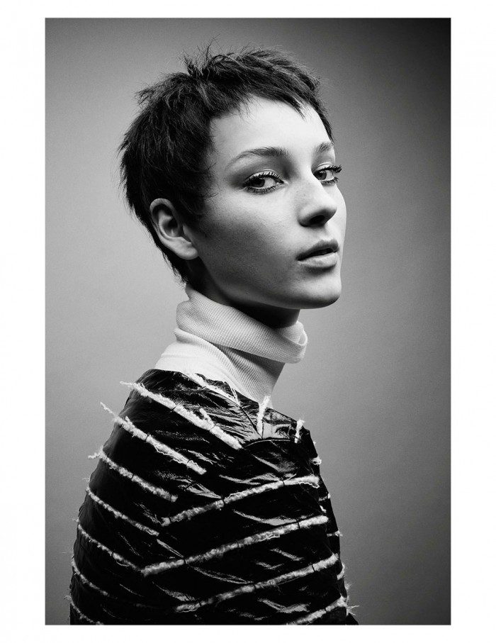 A black and white photo of a woman with short hair.