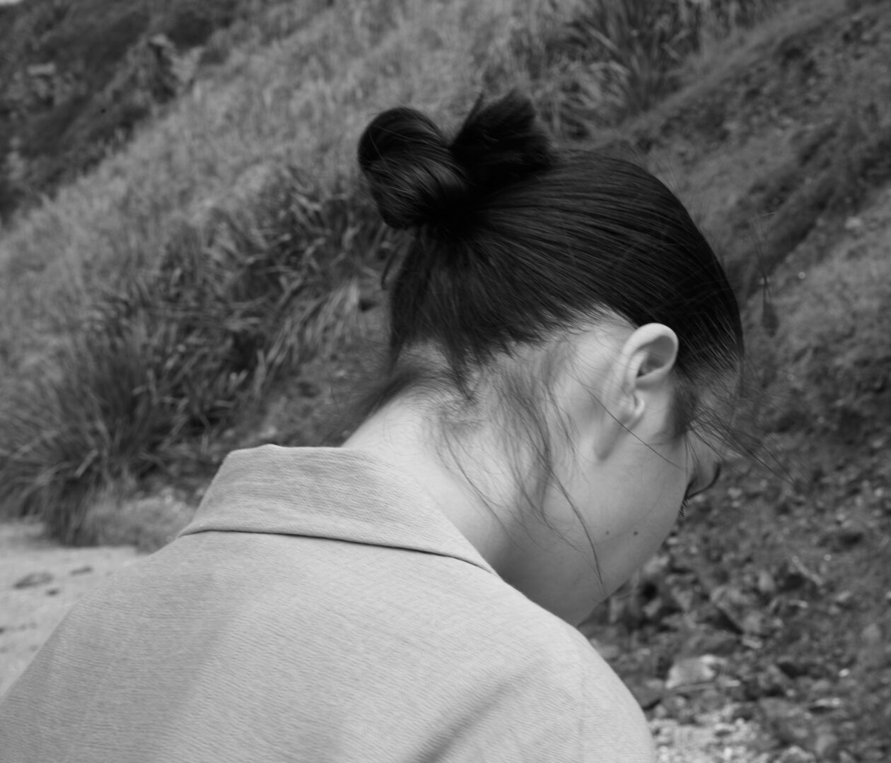 A black and white photo of a woman with a ponytail.