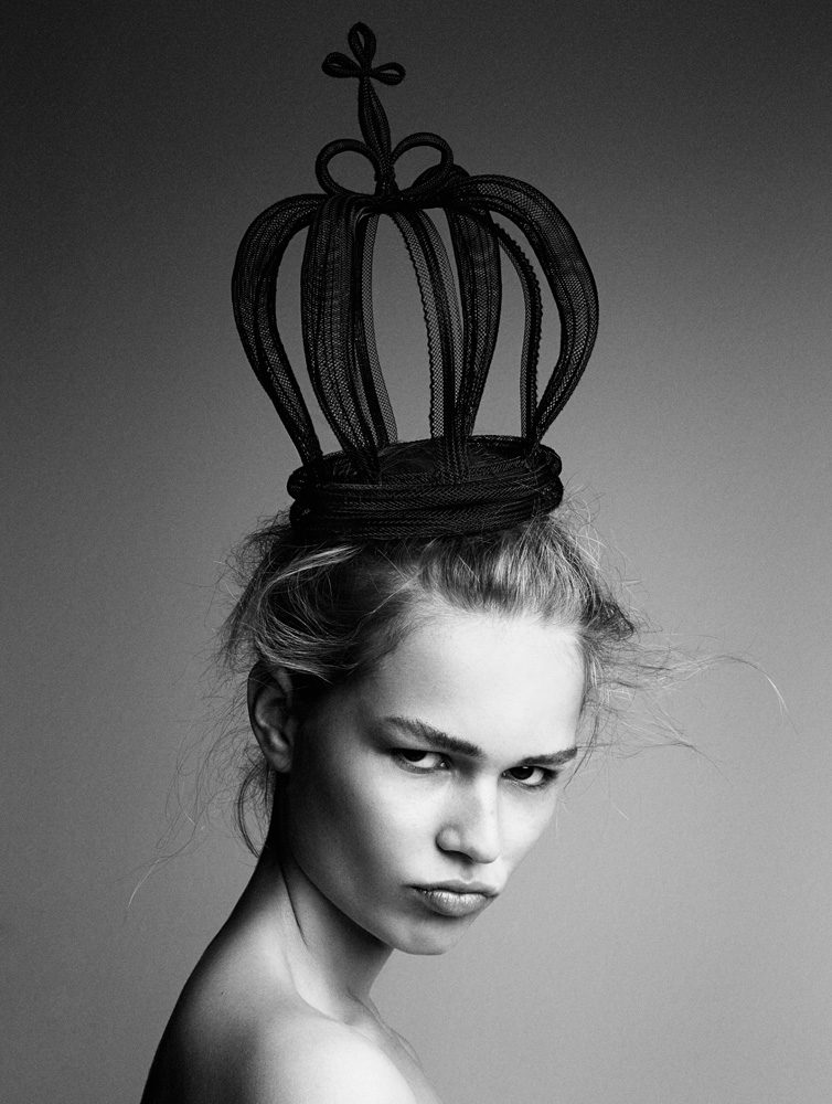 A black and white photo of a woman wearing a crown.