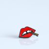 A "Lips" enamel lapel pin by LH™ with a mouth on it.